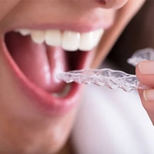 Close-up of person rinsing mouth with water after dental treatment or procedure.