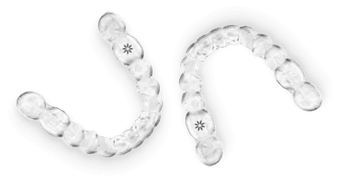 Clear dental aligners with small attachment buttons arranged in curved rows.