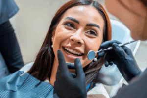 Happy patient receiving dental examination and treatment from dentist in Prosper, TX.
